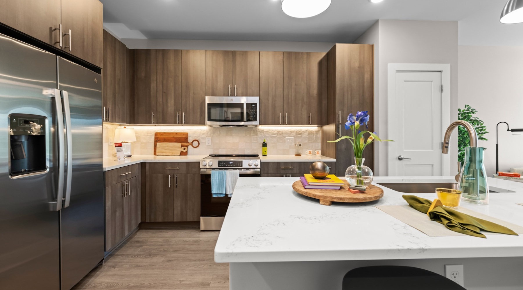 Kitchen with large island and stainless appliances at our NoDa apartments.