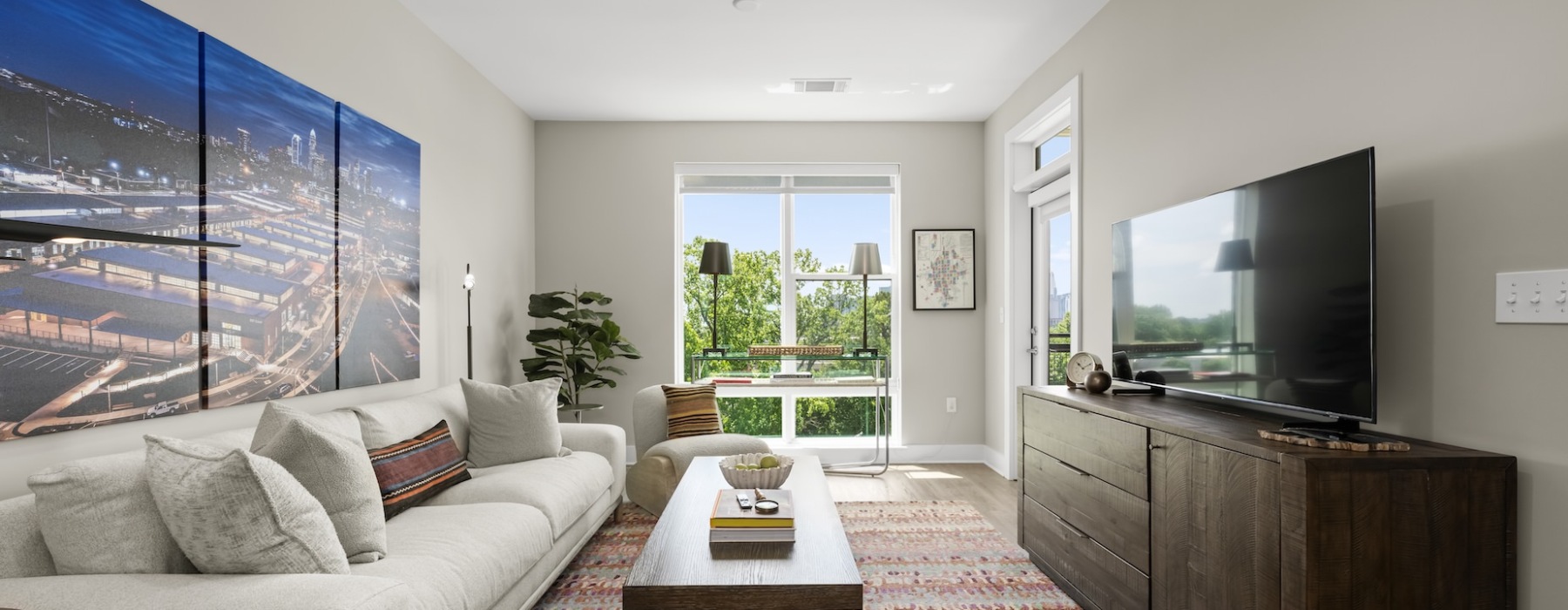 View of a modeled living room with natural light at Kinship apartments near Camp North End.
