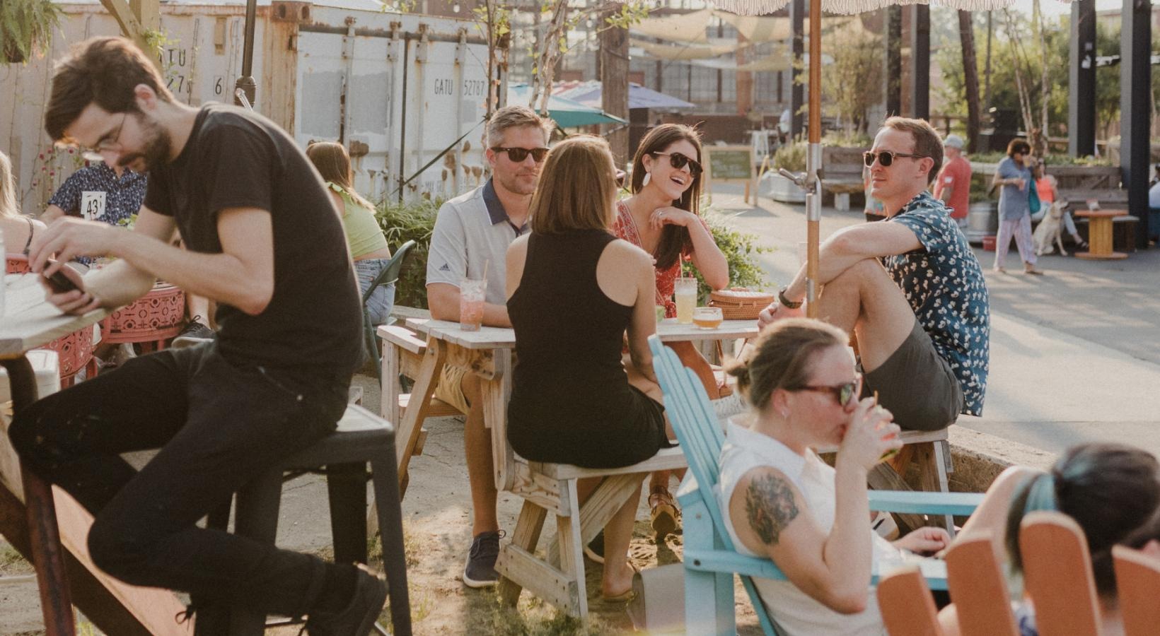 Find your perfect fit at Kinship a group of people sitting at tables