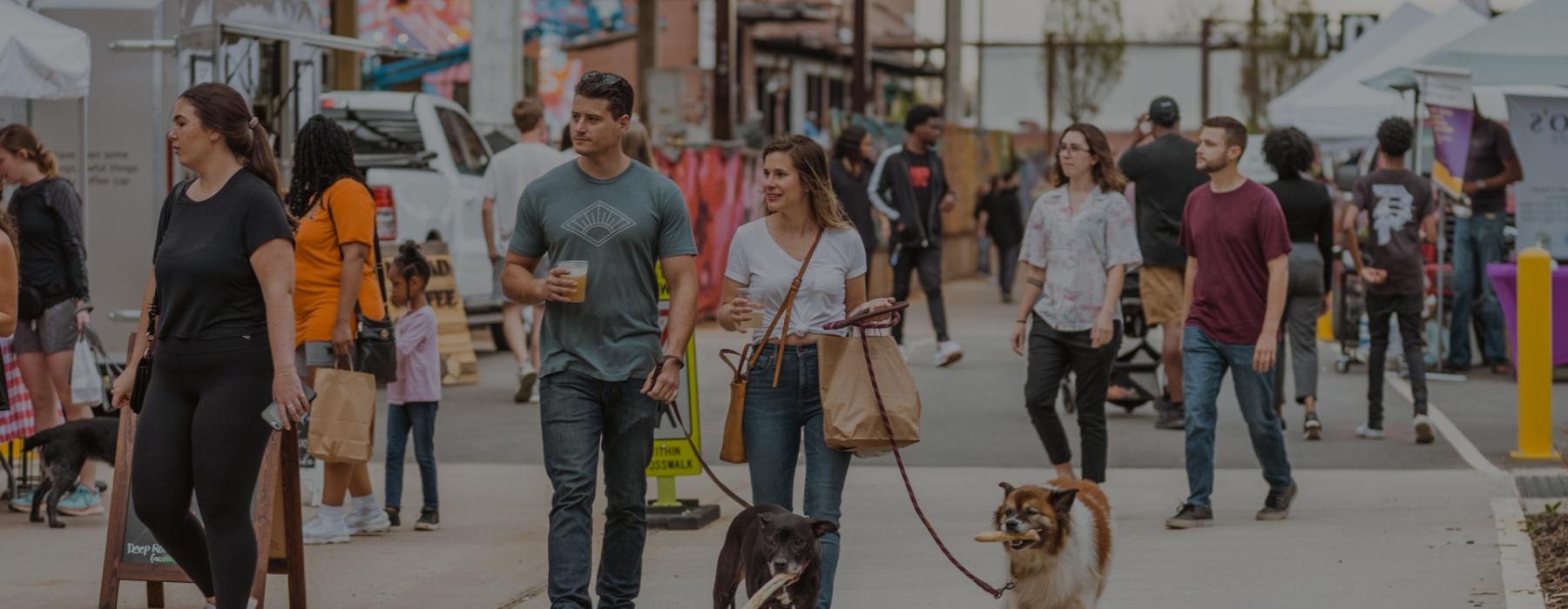 a group of people walking dogs