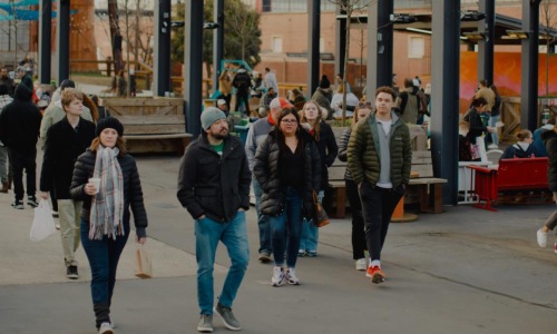 a group of people walking on a street