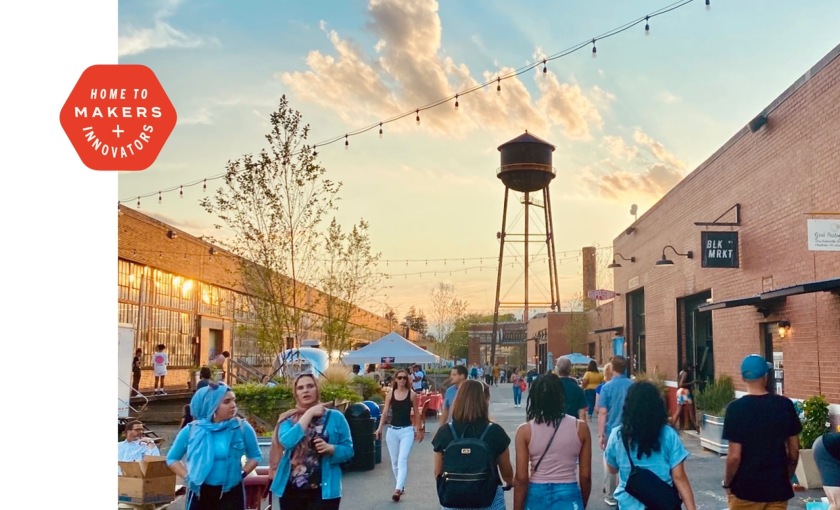 A bustling community in the heart of Charlotte a water tower and a small gathering of people